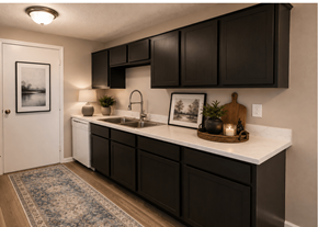 Dallas apartment for rent - A kitchen with black cabinets and a white countertop.