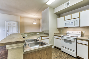 Arlington apartment for rent - A kitchen with white appliances and a sink in Arlington, TX.