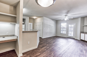 Arlington apartment for rent - A spacious room with a ceiling fan and a large window in Arlington, TX.
