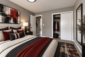 Jacksonville apartment for rent - A bedroom with a large bed and a painting on the wall.