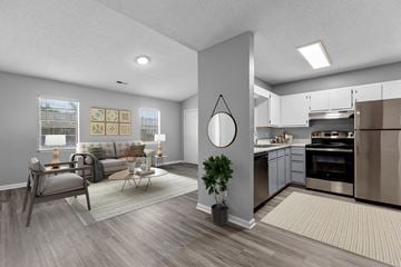 Greenville apartment for rent - the living room and kitchen of an apartment with a couch and a table