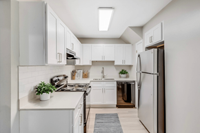 Wilson apartment for rent - a white kitchen with white cabinets and a stainless steel refrigerator at Cameron, North Carolina, 27893