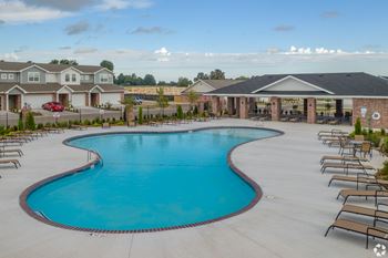 A large outdoor swimming pool surrounded by lounge chairs.