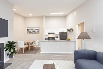 Fayetteville apartment for rent - a living room and kitchen with a couch and a table