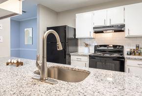 Fayetteville apartment for rent - a kitchen with granite counter tops and black appliances at Henley, North Carolina, 28311