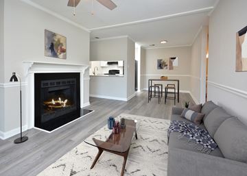 Fayetteville apartment for rent - a living room with a fireplace and a couch