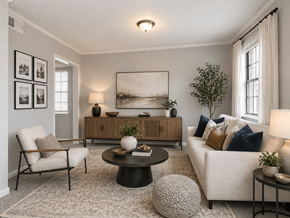 Jacksonville apartment for rent - A living room with a white sofa, a wooden cabinet, a chair, a table, and a painting on the wall.