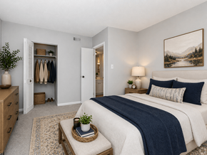 Jacksonville apartment for rent - A bedroom with a large bed and a painting on the wall.