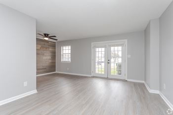 A room with a sliding door and a ceiling fan.