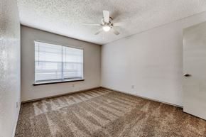 Balch Springs apartment for rent - an empty bedroom with a ceiling fan and a window
