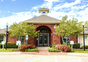 Arlington apartment for rent - the front of Addison Park Apartments in Arlington, TX with trees and flowers