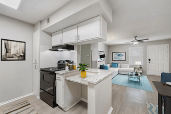 A kitchen and living room with a counter top