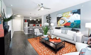 Grand Prairie apartment for rent - A living room with a white couch and a painting on the wall.