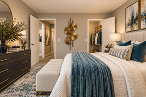 Fayetteville apartment for rent - A bedroom with a large bed and a dresser with a plant on top.