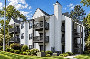 Fayetteville apartment for rent - A white apartment building with black balconies and a black gate.