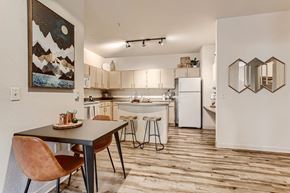 Fairview apartment for rent - Fairview Apartments for Rent - Lodges at Lake Salish - Apartment Dining Area With a Square Table, Two Chairs, and Wall Decorations