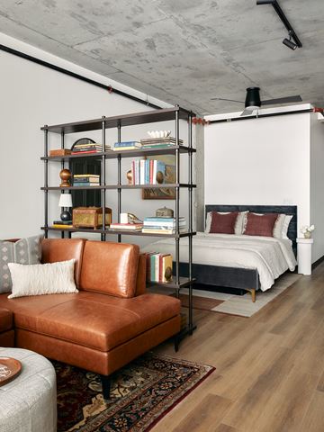 Nashville apartment for rent - a bedroom with a bed and a bookshelf in a loft