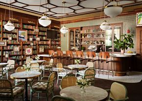 Portland apartment for rent - a restaurant with tables and chairs and a library filled with books