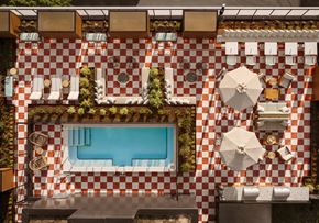 Portland apartment for rent - arial view of the pool area of a hotel with a swimming pool and tables