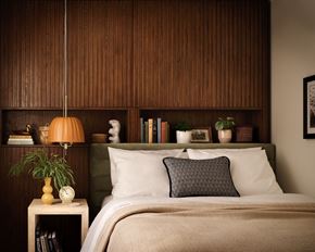 Portland apartment for rent - a bedroom with a bed with a wooden wall behind it