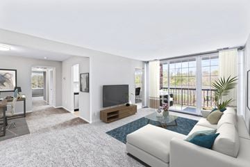 Burtonsville apartment for rent - A living room with a white couch and a television.