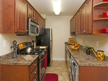 Greenbelt apartment for rent - a kitchen with stainless steel appliances and granite counter tops