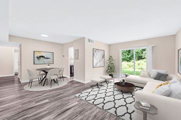 Annandale apartment for rent - A living room with a grey sofa, a round table with chairs, and a painting on the wall.