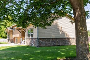 Walla Walla triplex for rent - a house with a stone facade and a tree