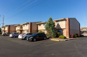 Walla Walla apartment for rent - a row of apartment buildings with cars parked in a parking lot
