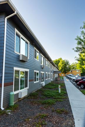 Walla Walla apartment for rent - the side of a building with a sidewalk and a parking lot
