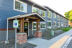 Walla Walla apartment for rent - a blue building with a parking sign in front of it