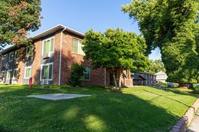 Walla Walla apartment for rent - the front of a brick house with a yard and a tree