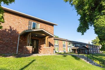 Walla Walla apartment for rent - a brick building with a green lawn and a tree