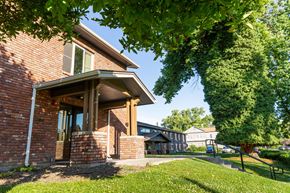 Walla Walla apartment for rent - the side of a brick house with a yard and a tree