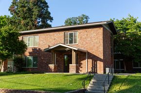 Walla Walla apartment for rent - the front of a brick house with a lawn and steps