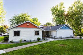 Walla Walla apartment for rent - a white house with an orange and white roof and a sidewalk