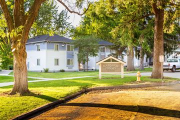 Walla Walla apartment for rent - a white house with a sign and trees in front of it