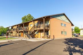 Walla Walla apartment for rent - the exterior of a building with balconies and a parking lot