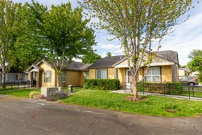 College Place triplex for rent - a group of houses in a neighborhood with a street and trees
