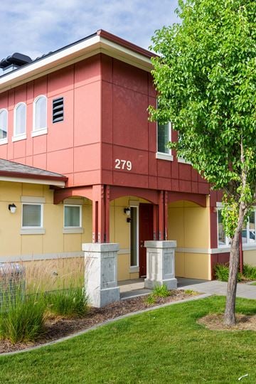 Walla Walla triplex for rent - a red building with a tree in front of it