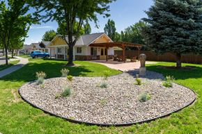 Walla Walla triplex for rent - a round rock garden in front of a house