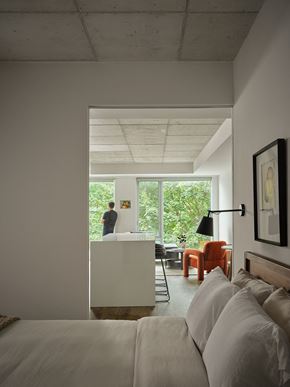 Toronto apartment for rent - a bedroom with a bed and a view of a kitchen and a living room