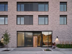 Toronto apartment for rent - people sitting in front of a brick building