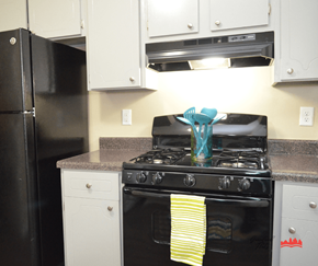 Memphis apartment for rent - a kitchen with white cabinets and black appliances
