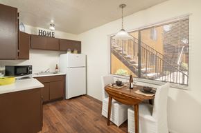 Tucson apartment for rent - A kitchen with brown cabinets and a white refrigerator.
