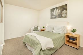 Tucson apartment for rent - A bedroom with a bed, nightstand, and a picture on the wall.