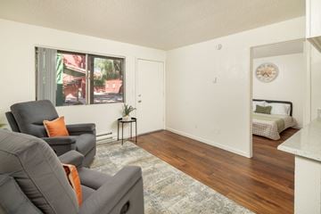 Tucson apartment for rent - A living room with a grey couch and a small table.