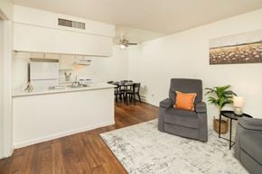 Tucson apartment for rent - A kitchen with a grey chair and a white fridge.