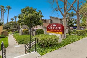 Ventura apartment for rent - A sign for Park Place Apartments is in front of a building.