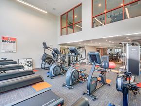 Salt Lake City apartment for rent - A gym with a variety of exercise equipment including treadmills, stationary bikes, and weight machines.